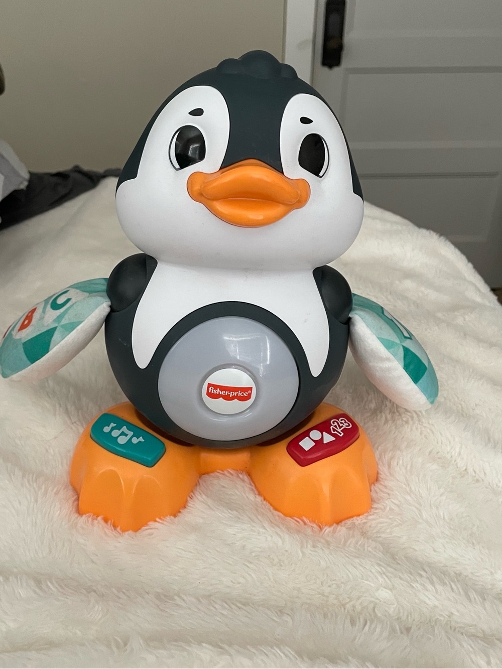 Fisher-Price Black & White Penguin Music and Light Learning Toy with Orange Feet